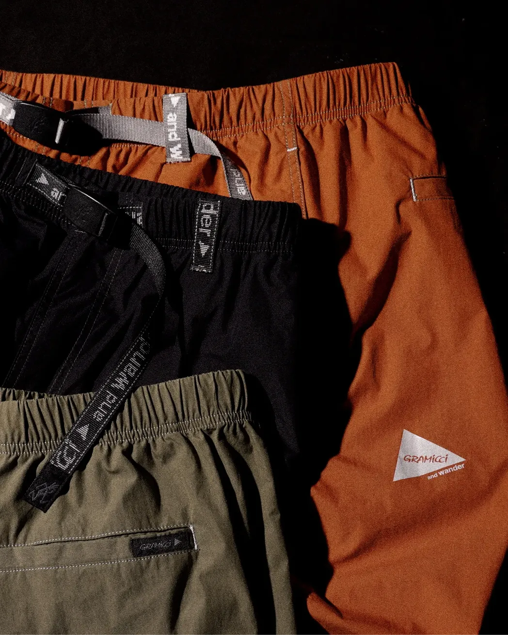 オレンジ色と黒のロングパンツとカーキ色のショートパンツ